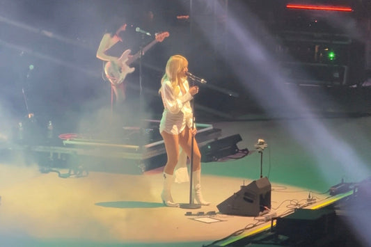 Cannons performing live under neon lighting at the Greek Theatre in Berkeley during the Afterglow Tour